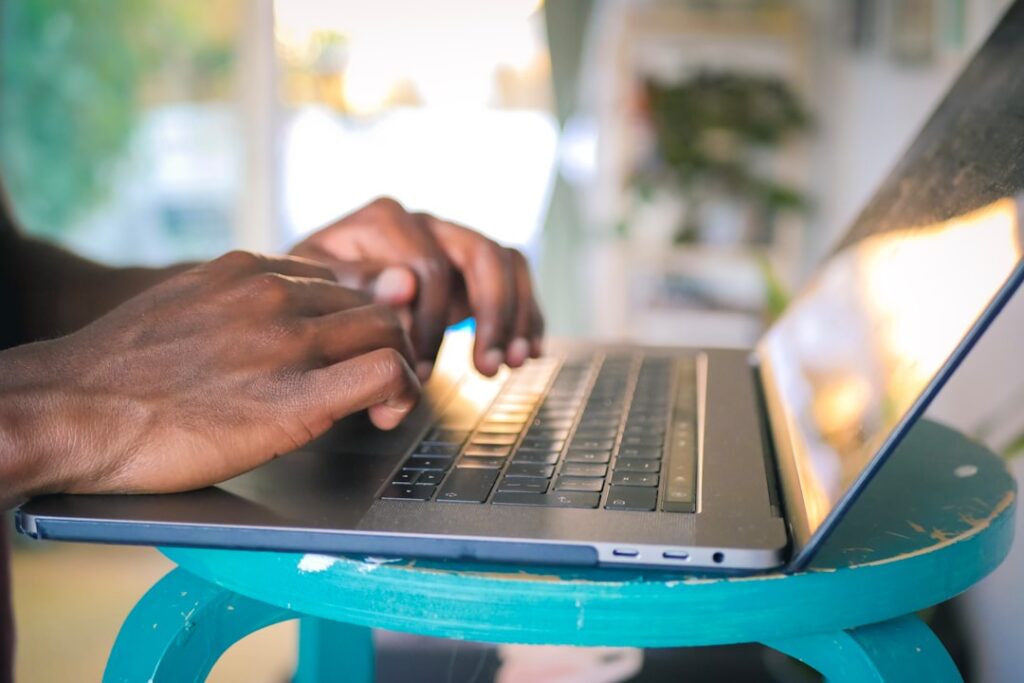 Med spa owner reviewing email marketing campaign results on a laptop