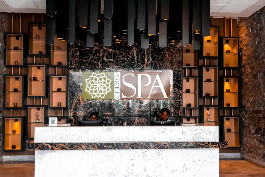 Med spa receptionist helping client leave a Google review on a tablet at the front desk