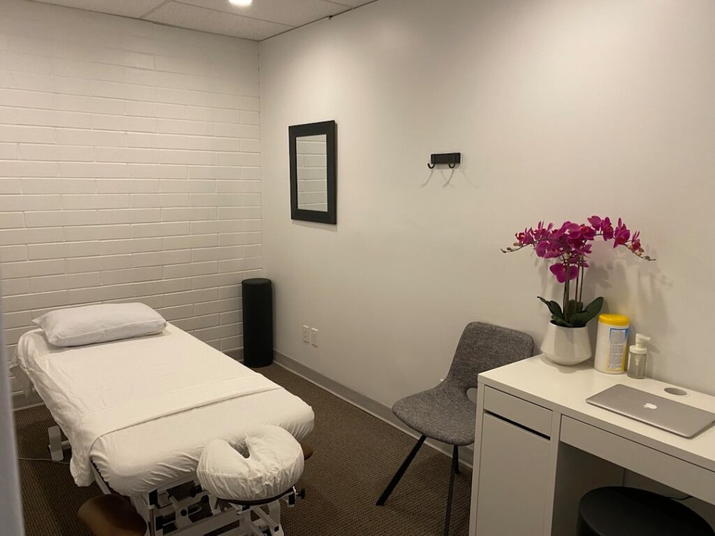 Med spa owner reviewing conversion rate optimization data on a laptop at the front desk