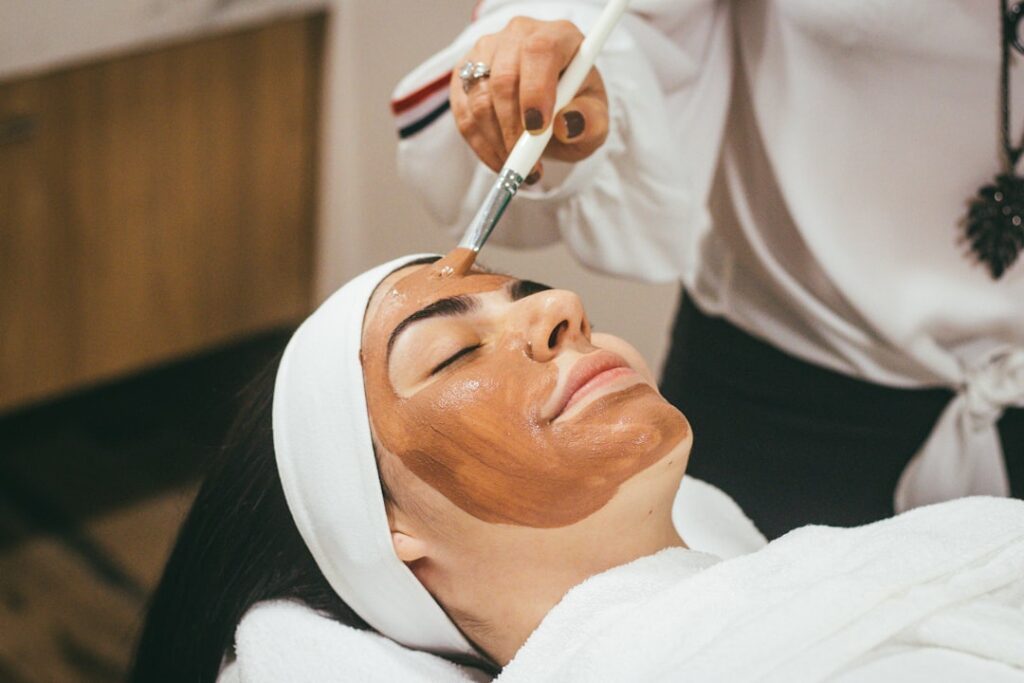 Client receiving a facial mask treatment at a modern med spa