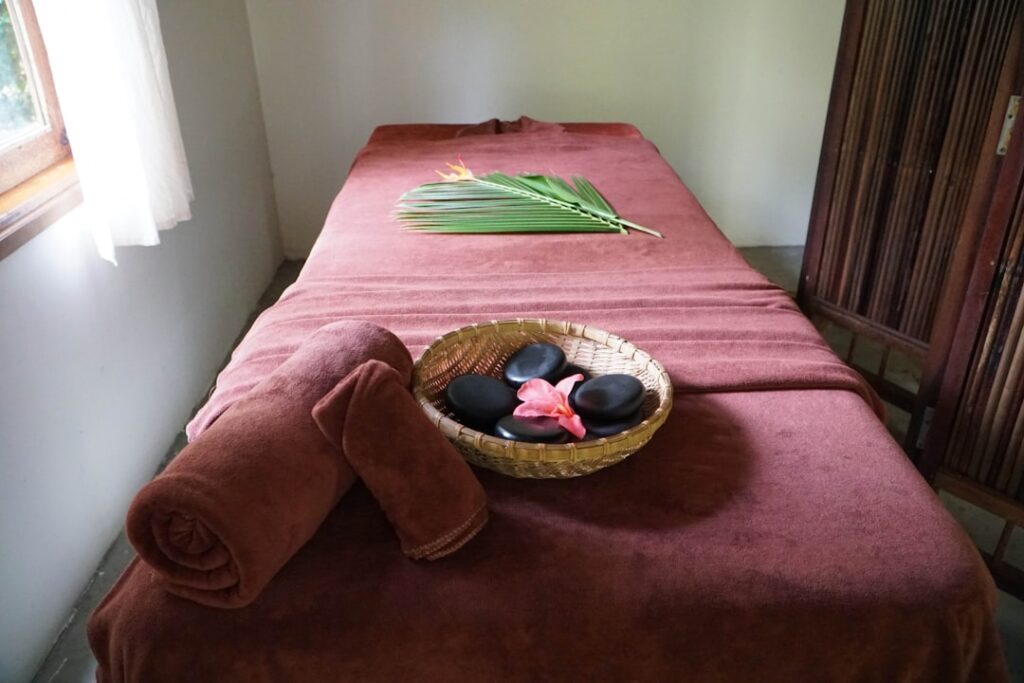 Spa still life with rolled towels and candles in soft light