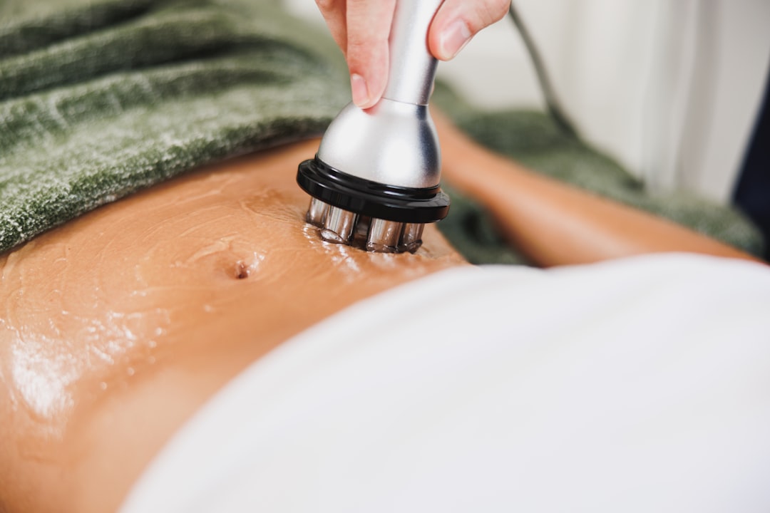 Med spa owner reviewing Google Ads quality score dashboard on laptop to lower cost per click