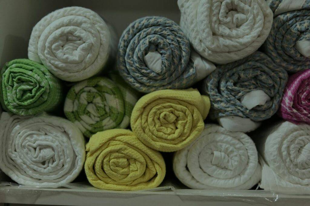 Neatly folded linen towels on a marble surface representing med spa membership program marketing